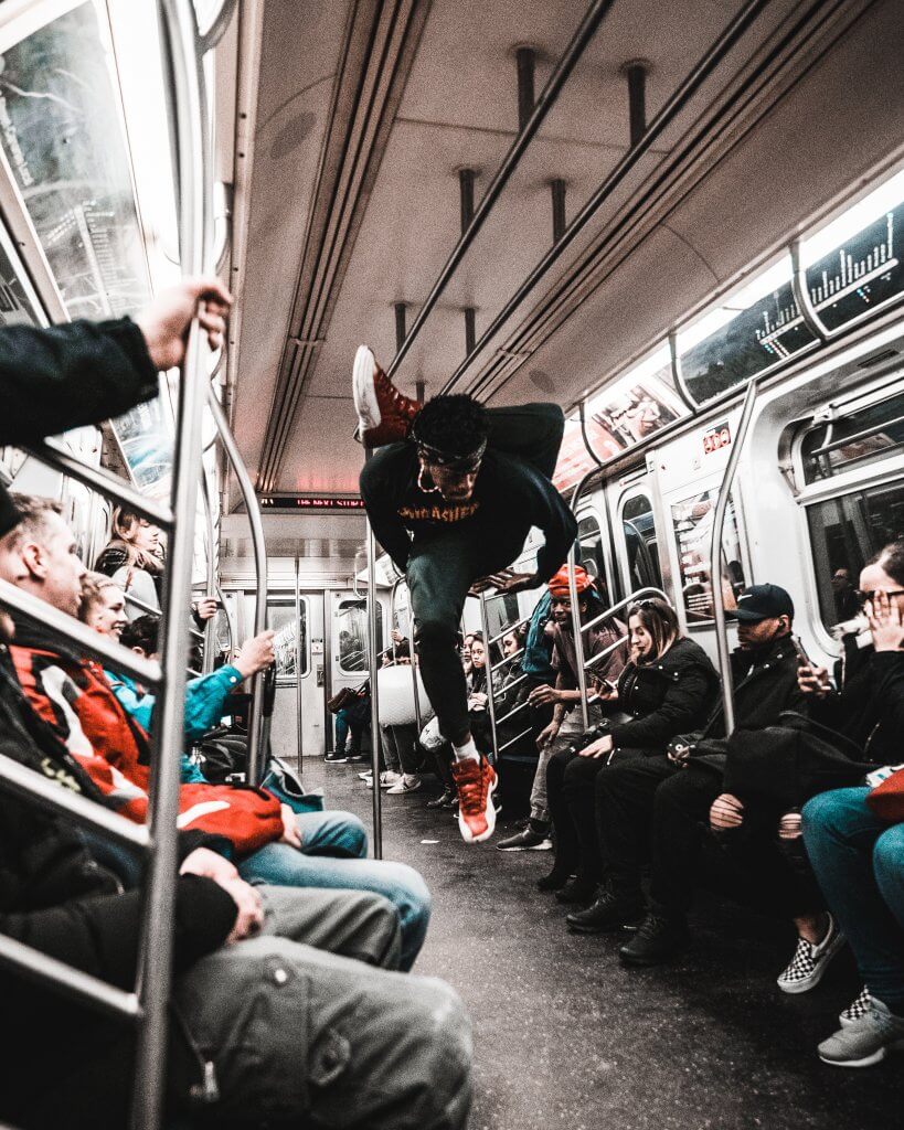 man breakdances in a metro